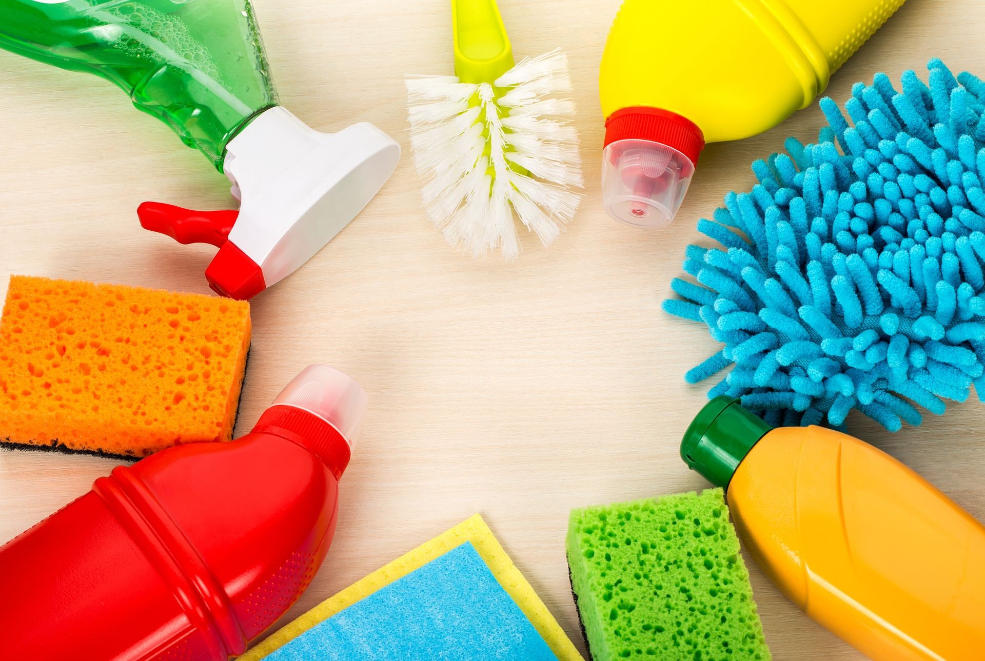 cleaning supplies on wooden background, top view